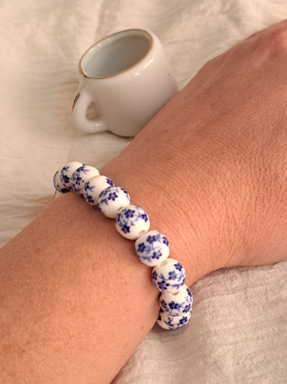 Blue flowers on white beads bracelet