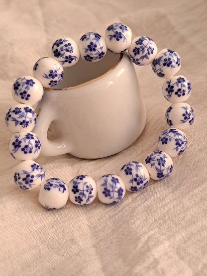 Blue flowers on white beads bracelet